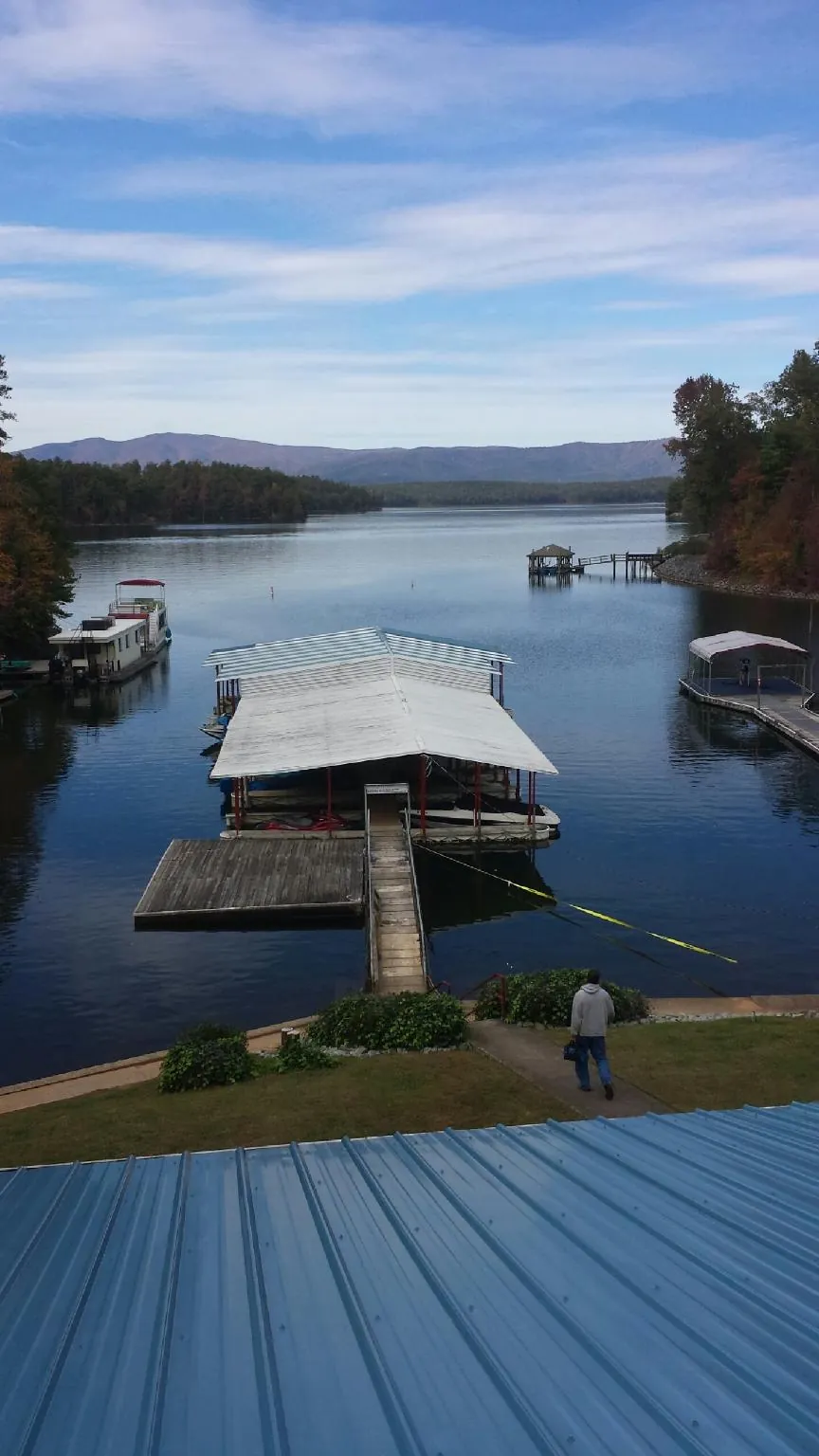 View across a lake from a newly installed blue metal roof in Mount Morris